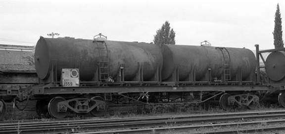 A large long train on a steel track

Description automatically generated