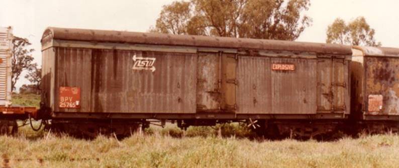 A train on a track near a field

Description automatically generated