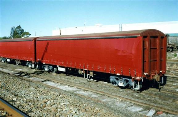 A large long train on a steel track

Description automatically generated