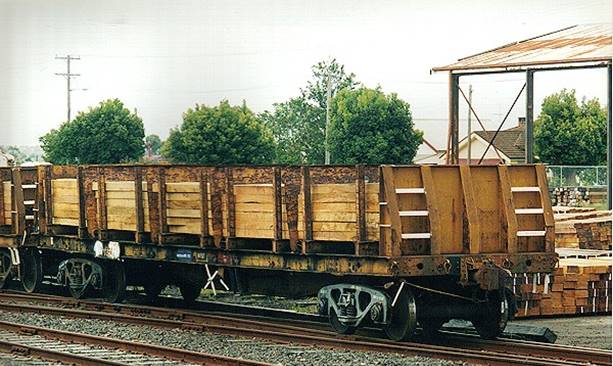 A large long train on a steel track

Description automatically generated